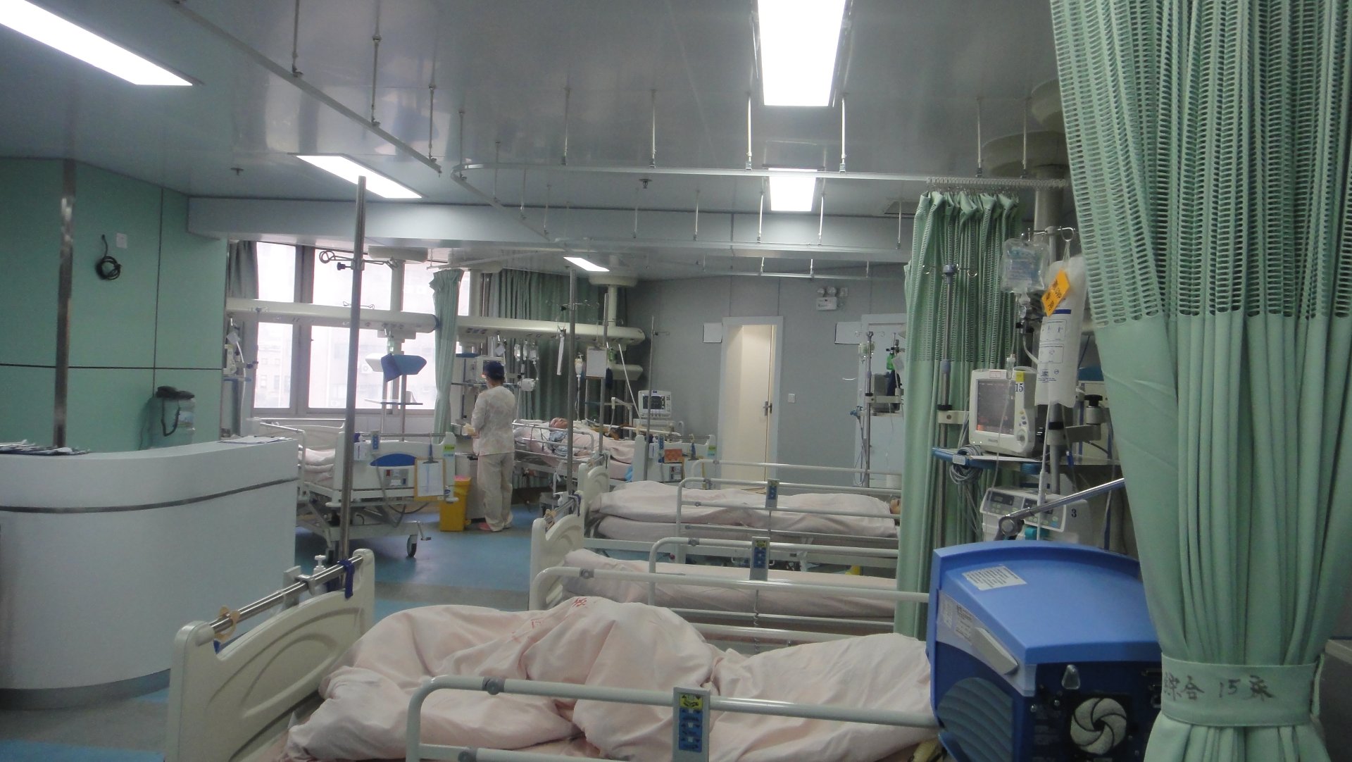 Full Bedside View of an ICU Room with the New ICU Bridge Full bedside view of an ICU room at Shanghai Jing'an District Central Hospital with the new ICU bridge supporting a patient monitor and infusion setup above the bed