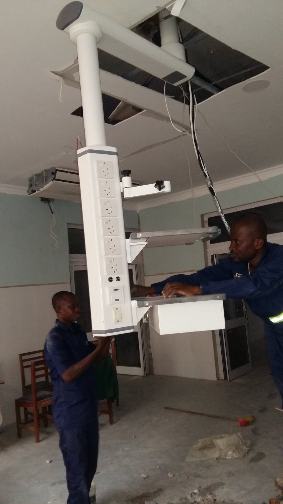 Installation team of medical pendant system working at RUMA Fertility & Specialist Hospital in Ghana