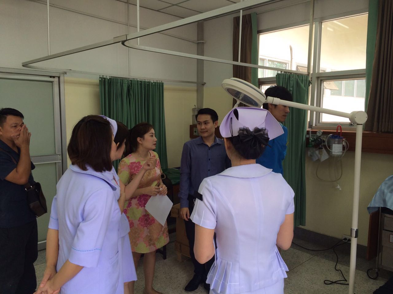 LED L260 wall-mounted medical examination light in a Thai hospital corridor and treatment area