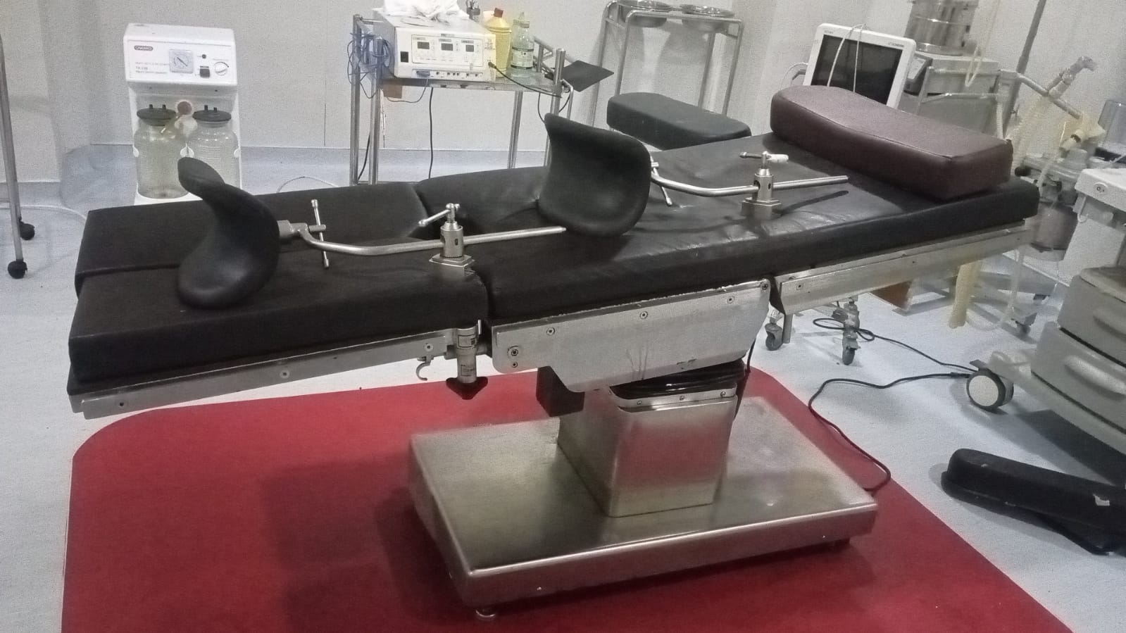 TDY-1 Electric Operating Table in active service at an Indonesian hospital after eight years of high-frequency surgical use, full tabletop view with knee crutches, headrest and segmented patient positioning plates.