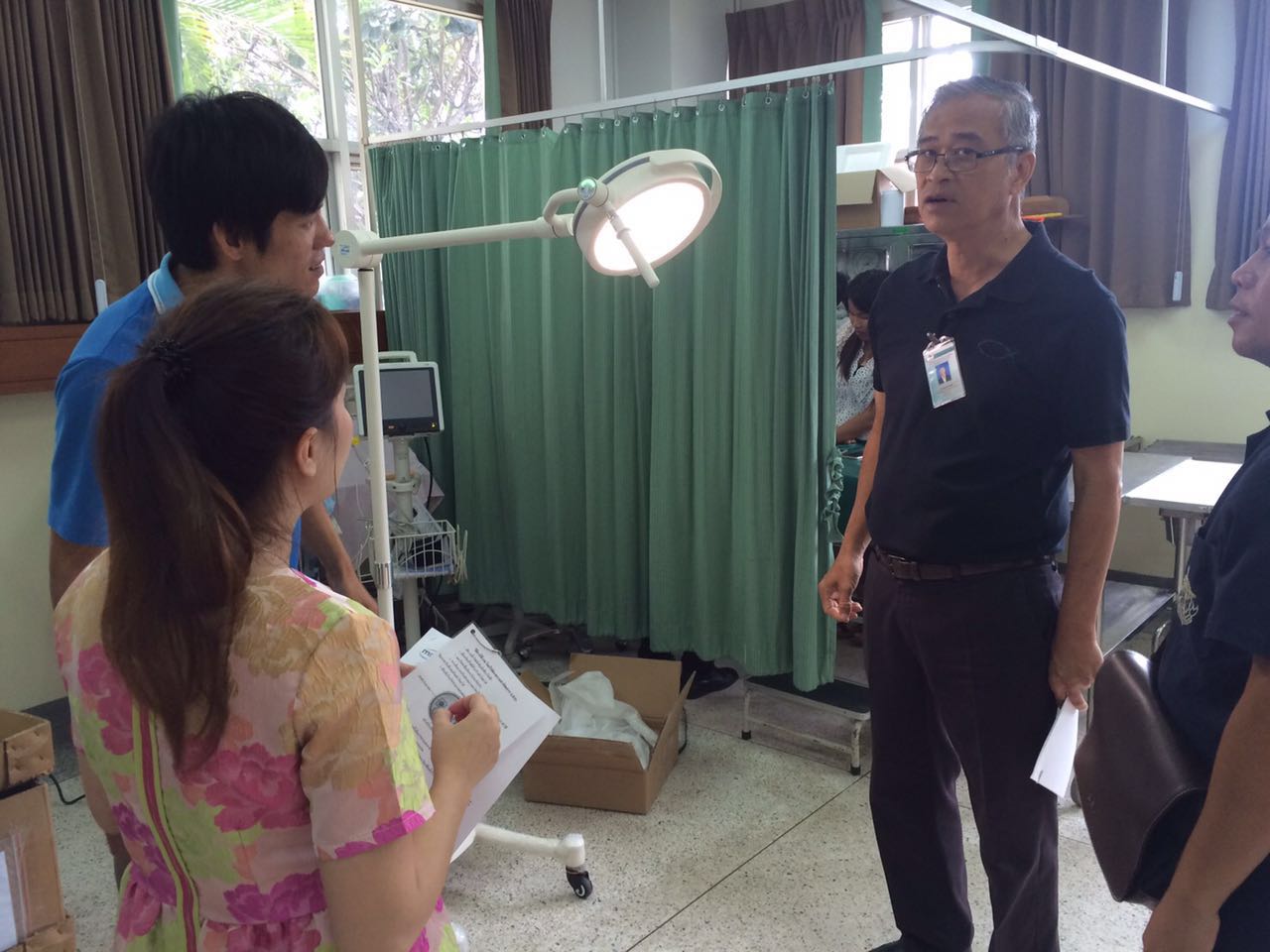 Mobile LED L260 examination light in a Thai hospital patient room with clinical team