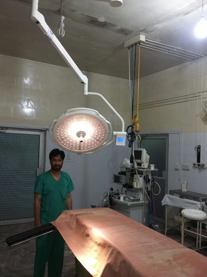 Pakistani military hospital surgeon standing beside the LEDD700/500 ceiling operating light dome during installation and clinical commissioning