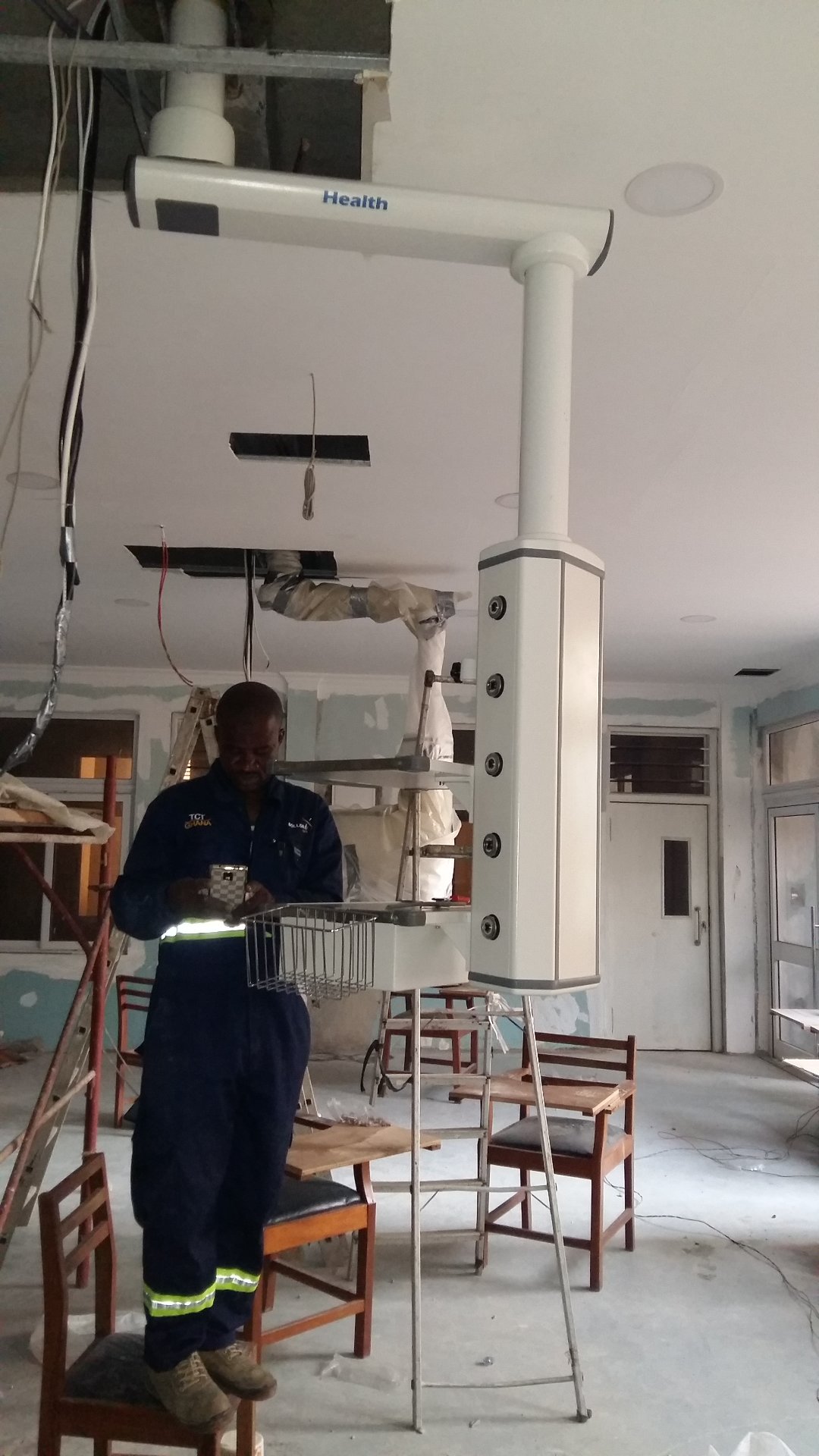 Ceiling-mounted medical pendant being installed by technicians at RUMA Fertility & Specialist Hospital in Ghana